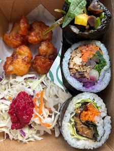 A variety of takeaway food items including sushi rolls and fried chicken wings
