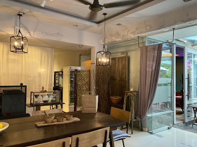 The image shows a modern dining area in an apartment or house located at Thao Dien, Saigon. The space features contemporary design elements such as pe