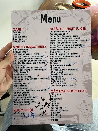 A menu from a Vietnamese restaurant named Thao Dien in Saigon showing various food and drink options with both English translations and some handwritt