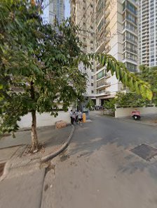 The image shows a street view of an urban residential area in Thao Dien, Saigon with high-rise buildings and greenery on the left side.