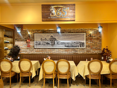 The image depicts the interior of a restaurant in Thao Dien, Saigon. It features several round tables with white tablecloths and wooden chairs with wo