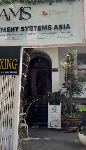 The image shows an exterior view of a business establishment named 'AMS Asia' which appears to be located in Thao Dien, Saigon. The signage indicates 