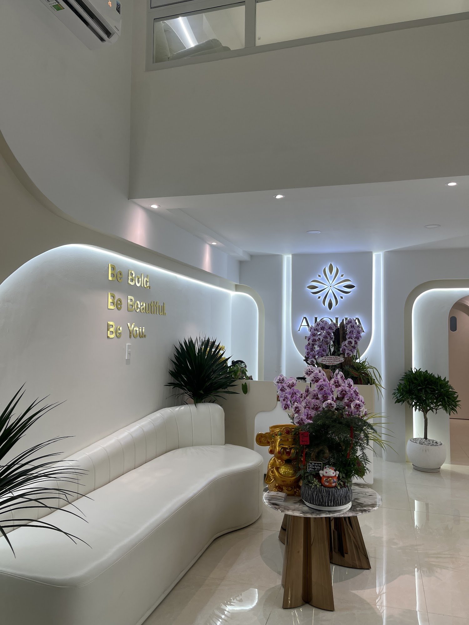 The image depicts a modern and stylish interior space within Thao Dien, Saigon. It features contemporary design elements such as sleek white furniture