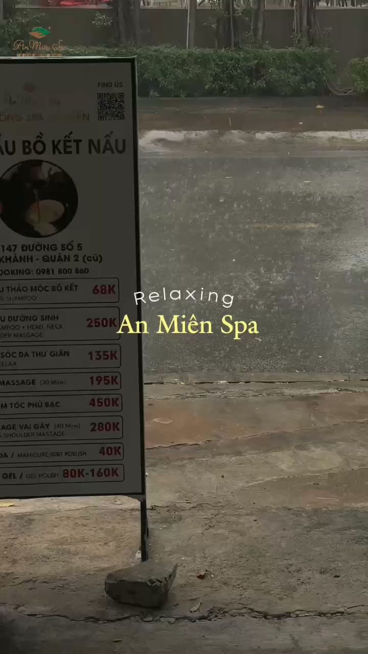 The image shows a signboard for 'An Mienia Spa' which is advertising various spa services with prices listed in Vietnamese dong (VND). The background 