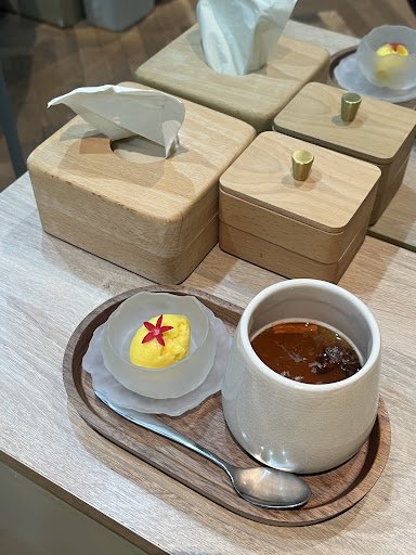 The image shows a neatly arranged table setting in what appears to be an upscale restaurant or cafe environment within Thao Dien, Saigon.