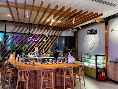 The image shows an interior view of a modern café or bar in Thao Dien, Saigon. The space features wooden slatted ceiling beams and contemporary decor