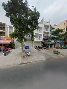 The image shows a street view of an urban area in Thao Dien, Saigon with multiple buildings and parked motorcycles on the side.