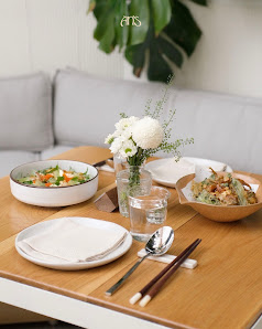 A neatly arranged dining table set for a meal in an indoor setting.