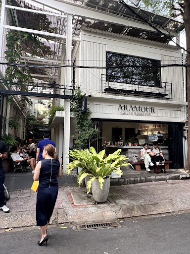 The image shows an exterior view of a coffee shop named 'Aramour Coffee House' located on Thao Dien street in Saigon, Vietnam.