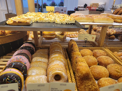 A bakery display case showcasing an assortment of pastries and breads.
