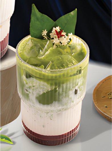 A refreshing green drink garnished with a sprig of mint and small white flowers on top.