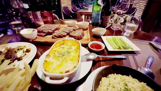 The image shows a dining table set in an indoor venue named Thao Dien, Saigon with various dishes and drinks laid out for consumption.