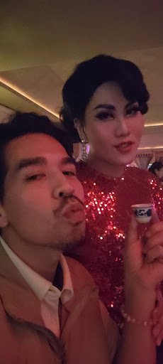 A man and a woman are posing for the camera at an indoor event in Thao Dien, Saigon.