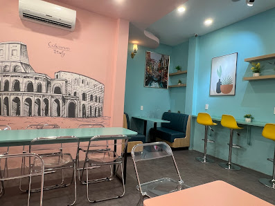 The image shows an interior space of a restaurant or cafe in Thao Dien, Saigon with modern decor and vibrant colors on the walls.