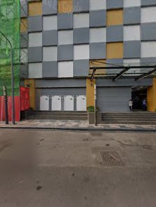 Exterior view of a commercial building in Thao Dien, Saigon. Features a modern facade with alternating gray and yellow square panels, a covered entran
