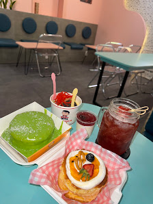 The image shows a table in an indoor setting at Thao Dien, Saigon with various food items and drinks on it.