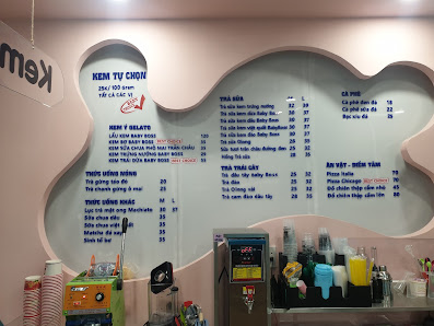 The image shows an interior view of a restaurant or cafe named 'Ken TV Chow' with pink walls and decorative elements such as a large, cloud-shaped men