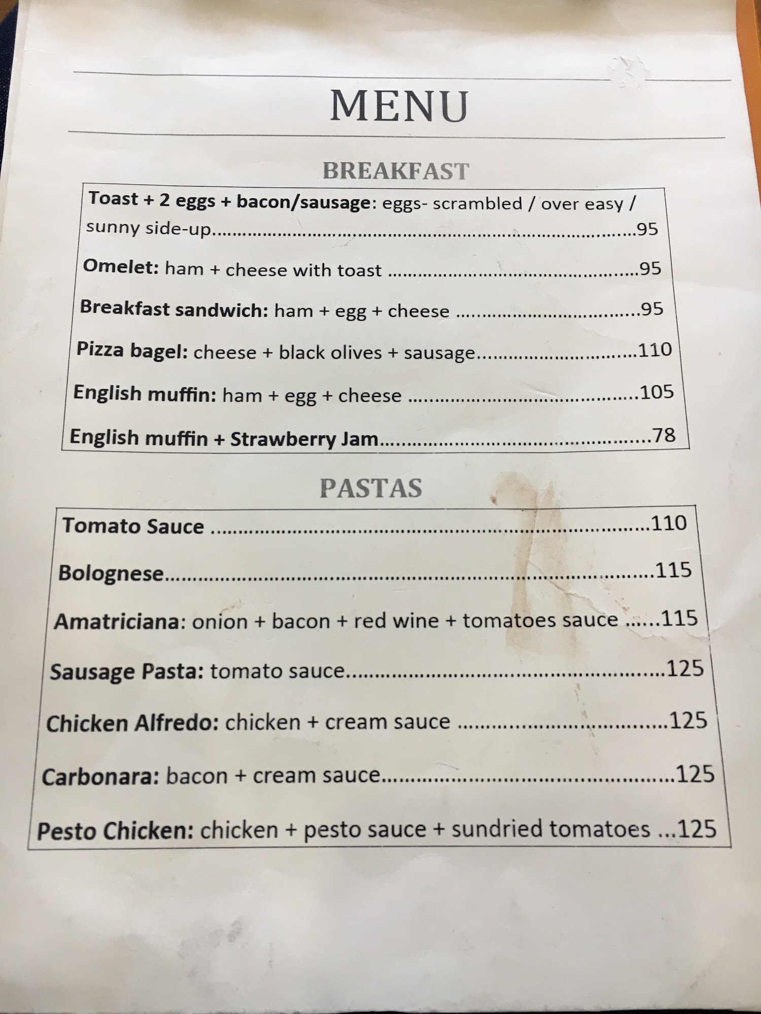 A menu from a restaurant in Thao Dien, Saigon displaying breakfast and pastas options with prices listed.