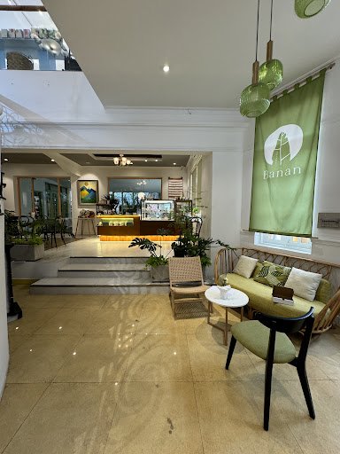 The image shows an interior space of a venue named 'Banana', which appears to be a modern and well-lit lobby or waiting area with seating arrangements