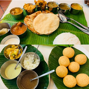 A variety of Indian vegetarian dishes including rice, roti (flatbread), and several types of curry
