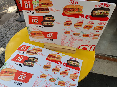 The image shows a menu board displaying various food items and their prices at Thao Dien in Saigon.