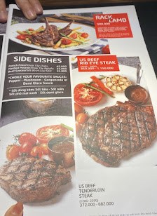 The image shows a menu from Thao Dien, Saigon featuring various dishes such as steak and side dishes.