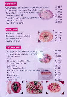 A menu displaying various food items and their prices in Vietnamese Dong (VND). The background is pink with white text for readability.