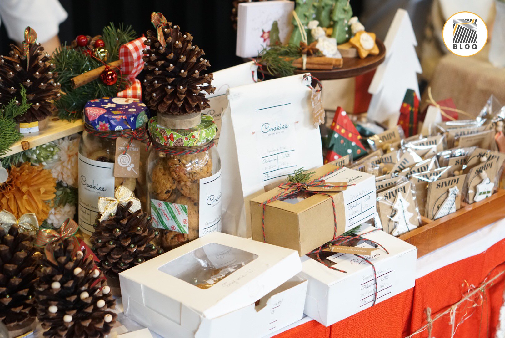 The image shows a festive display of holiday-themed baked goods and decorations on a table in what appears to be an indoor venue, likely during the Ch