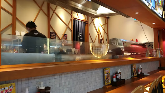 The image shows an interior view of a fast-food restaurant or diner in Thao Dien, Saigon. The counter is visible with various condiments and promotion