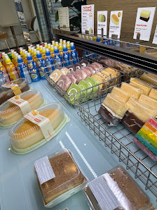 The image shows a display case in an establishment named Thao Dien, Saigon, filled with various packaged food items such as cakes and pastries.