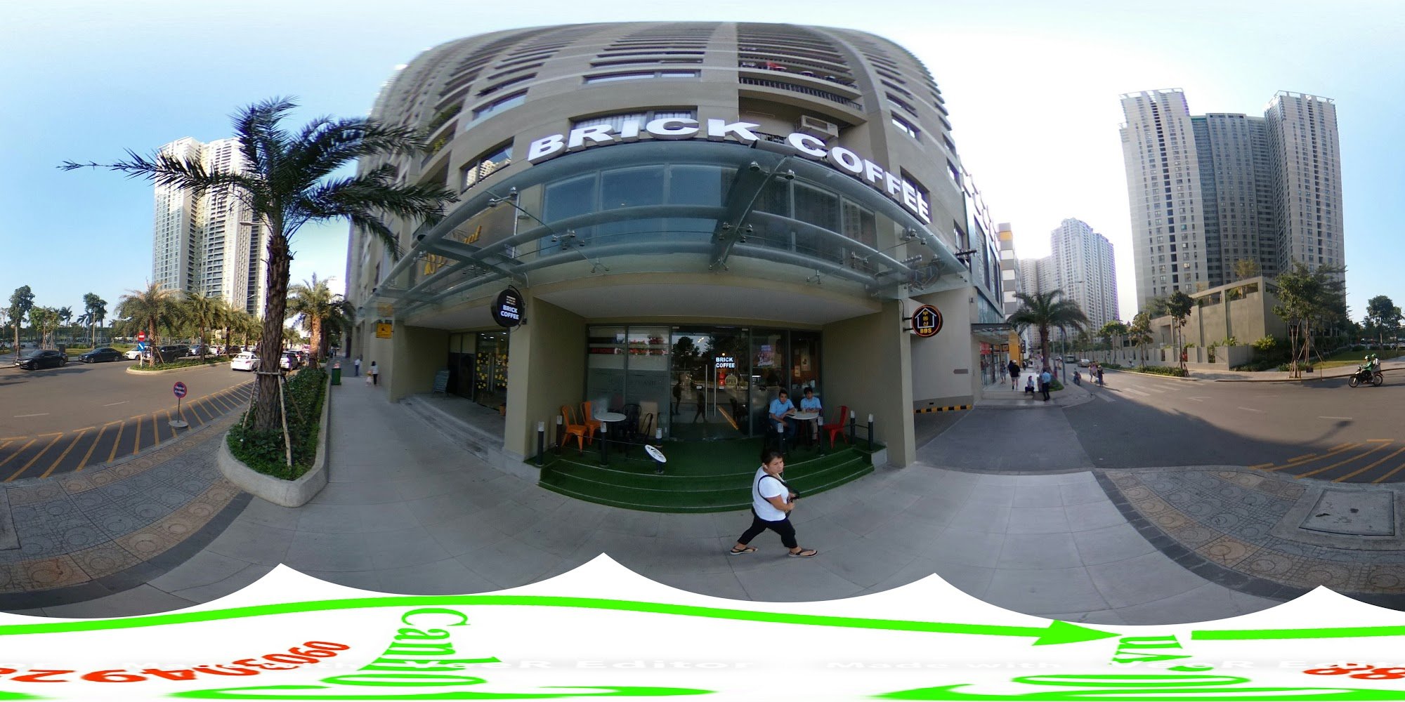 The image depicts the exterior of Brick Coffee, a coffee shop located in Thao Dien, Saigon. The building features a modern curved facade with large gl