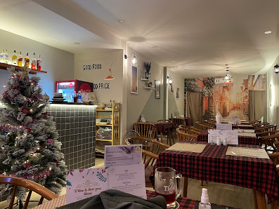 The image shows an indoor dining area of a restaurant named '376 FOOD & COFFEE'. The decor includes festive elements such as Christmas trees and red p