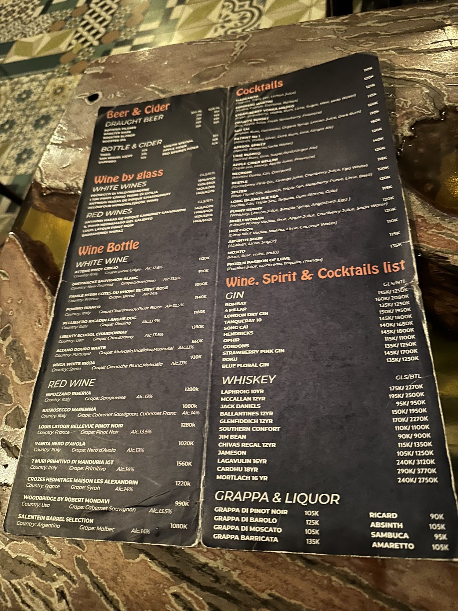 A menu from a venue in Thao Dien, Saigon displaying various beverage options including beer & cider, wine by glass and bottle, cocktails, spirits, whi