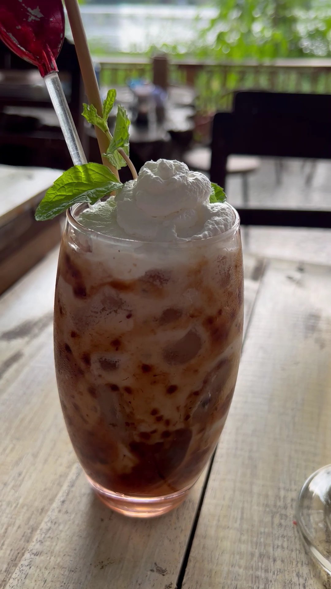 A close-up of a refreshing drink in an outdoor setting at Thao Dien, Saigon.