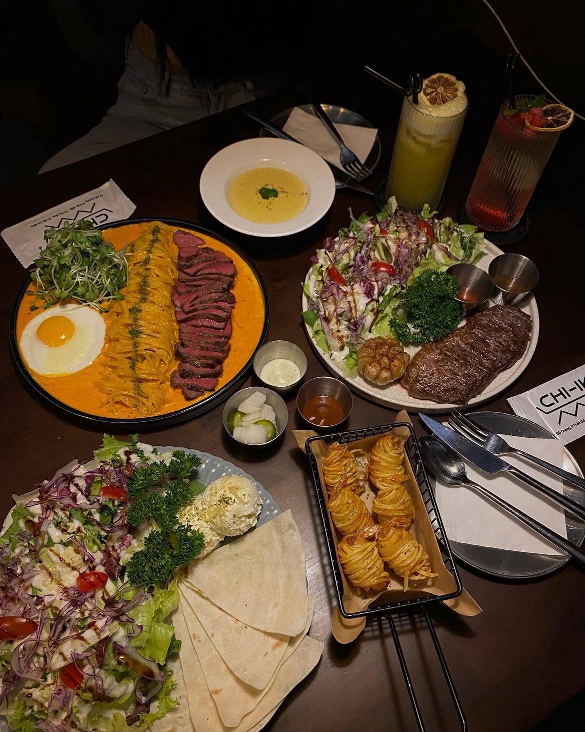 Steak and Pasta Platter with Salad and Drinks