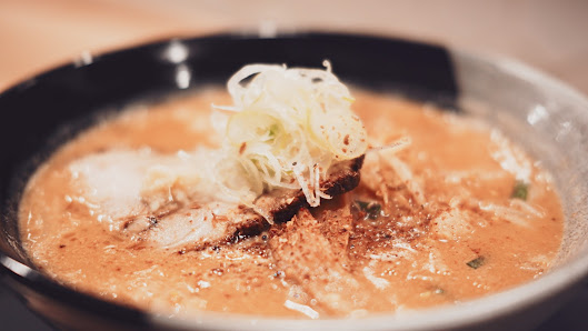 Ramen or Noodle Soup with Creamy Broth and Shredded Cabbage Garnish