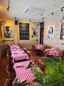 The image depicts the interior of a restaurant in Thao Dien, Saigon. It features multiple dining tables covered with red and white checkered tableclot