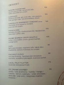 A dessert menu from a venue in Thao Dien, Saigon, listing various dessert items with descriptions and prices. Items include 'DUMBO CHOCOLATE' (110), '