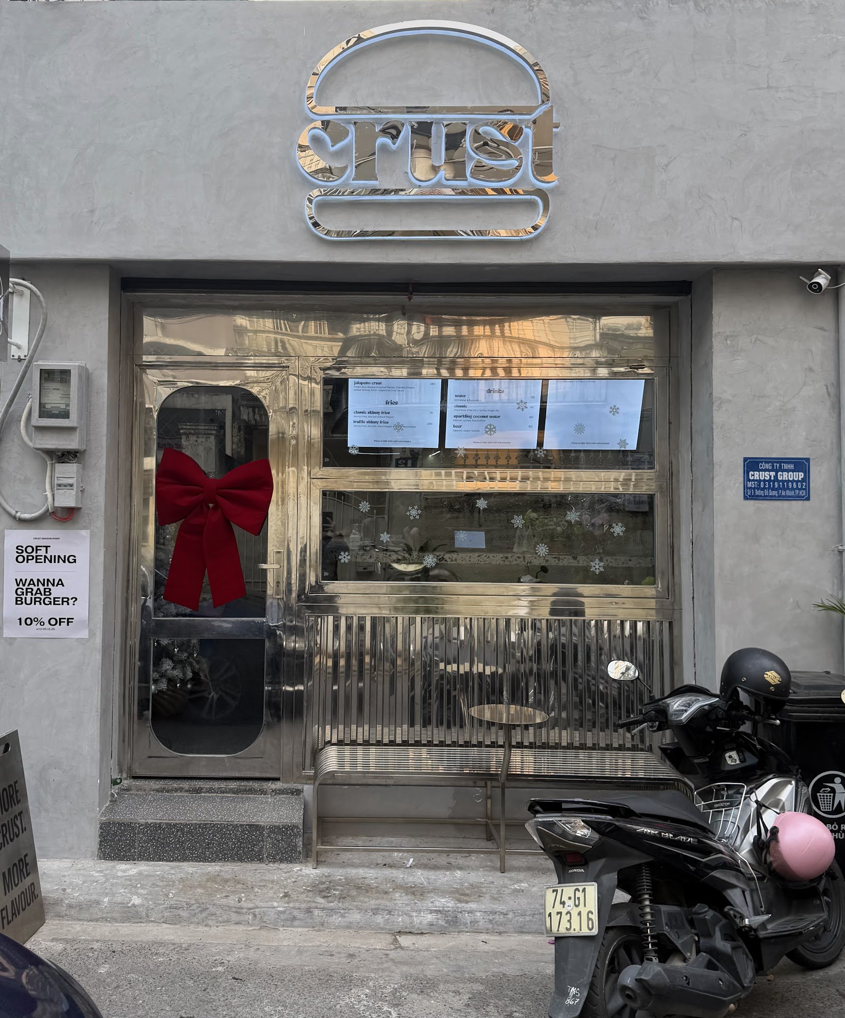 The image shows an exterior view of a restaurant named 'Crust' located in Thao Dien, Saigon. The establishment has a modern and minimalist design with