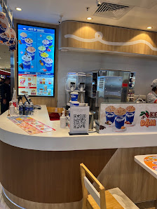 The image shows an interior view of a food service counter in Thao Dien, Saigon. The counter displays various items on the menu board above and has pr