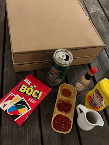 The image shows a variety of items laid out on a wooden surface which appears to be part of an outdoor setting in Thao Dien, Saigon.