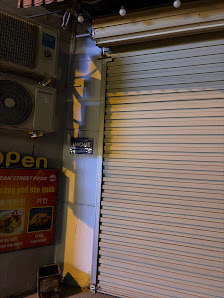 The image shows a closed shutter of what appears to be an establishment at night time in Thao Dien, Saigon.