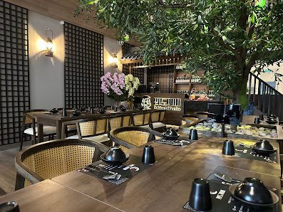 The image depicts an interior dining area of a restaurant or cafe in Thao Dien, Saigon. The space features modern decor with wooden elements and black