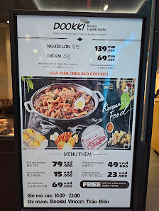 The image displays a menu board for 'Dookki' restaurant located in Thao Dien, Saigon. It features a prominent photo of a pot of food (likely a stew or