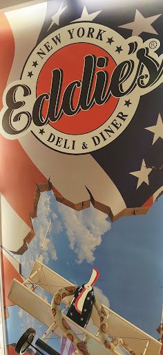 The image shows a part of the interior decor at Eddie's Deli & Diner in New York City as indicated by the signage on what appears to be an outdoor adv