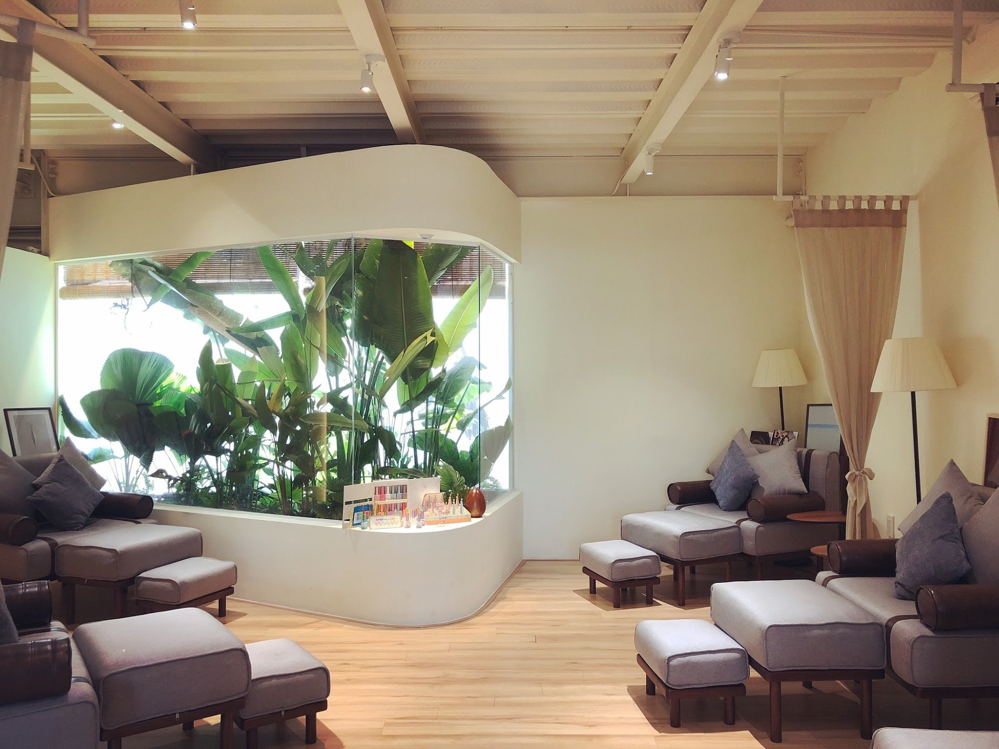 This image depicts a modern and cozy interior space within Thao Dien, Saigon. The room features comfortable seating arrangements with plush sofas and 