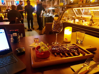 The image shows a cozy dining setting in an indoor venue named Thao Dien, Saigon. The focus is on the table with various dishes and drinks, including 