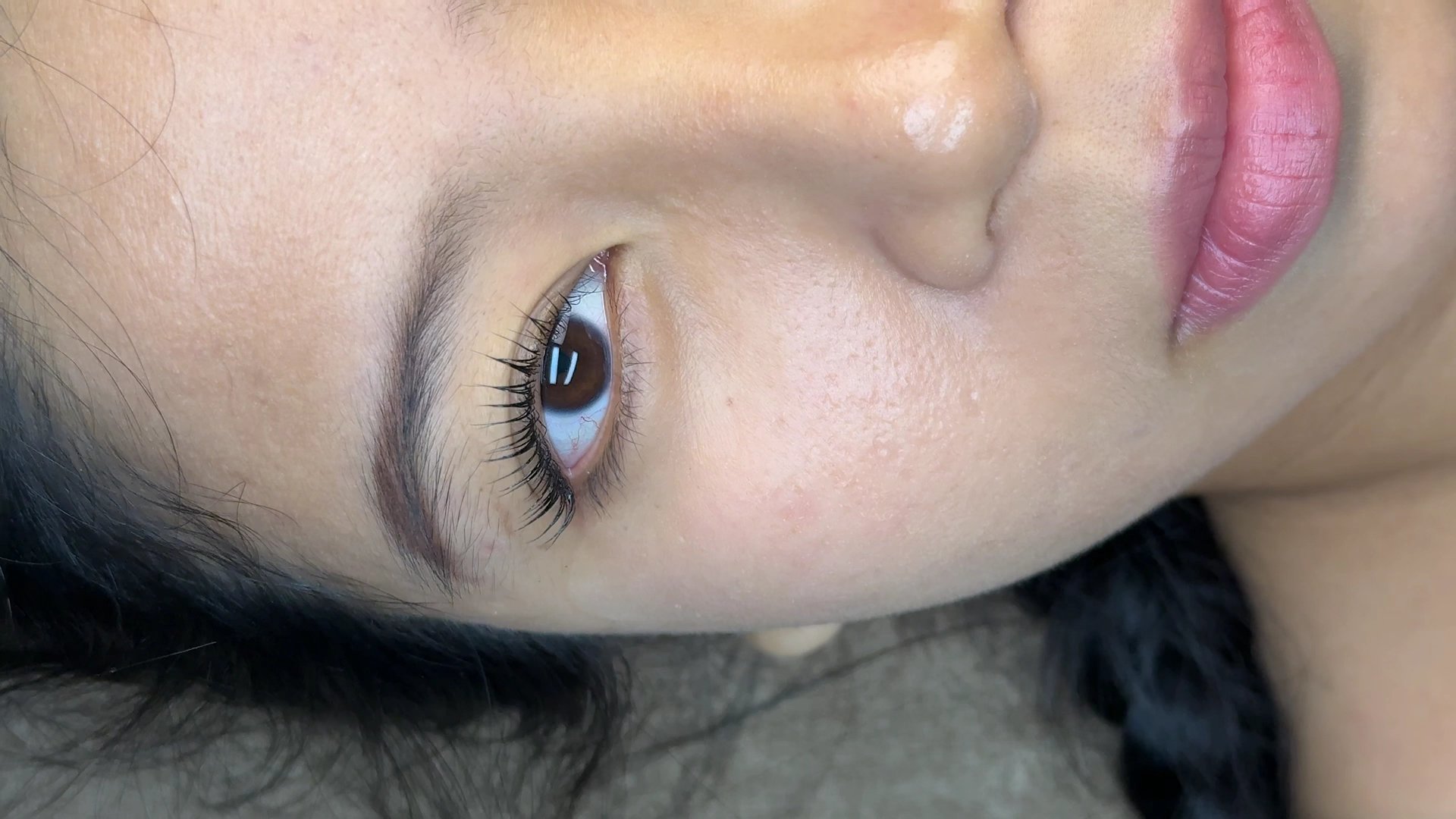 A close-up photograph of a person's eye and part of their face.