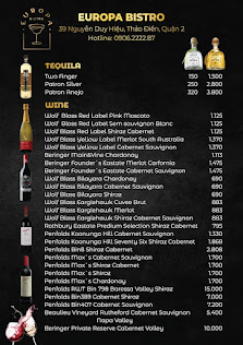 A menu from a venue in Thao Dien, Saigon featuring various alcoholic beverages such as tequila and wine with their respective prices listed.