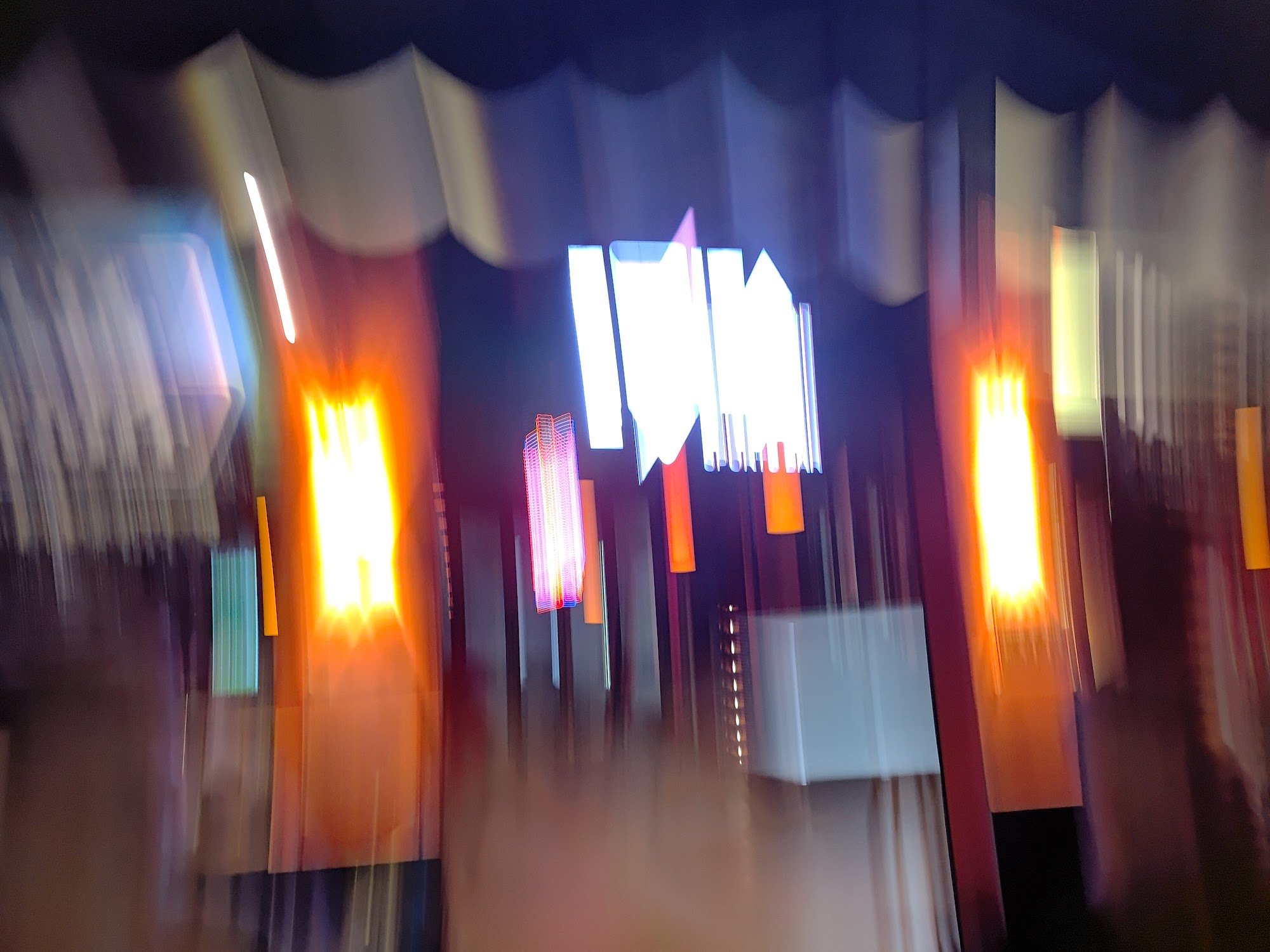 The image appears blurred and out of focus, depicting a vibrant interior space likely within an establishment such as a restaurant or bar in Thao Dien